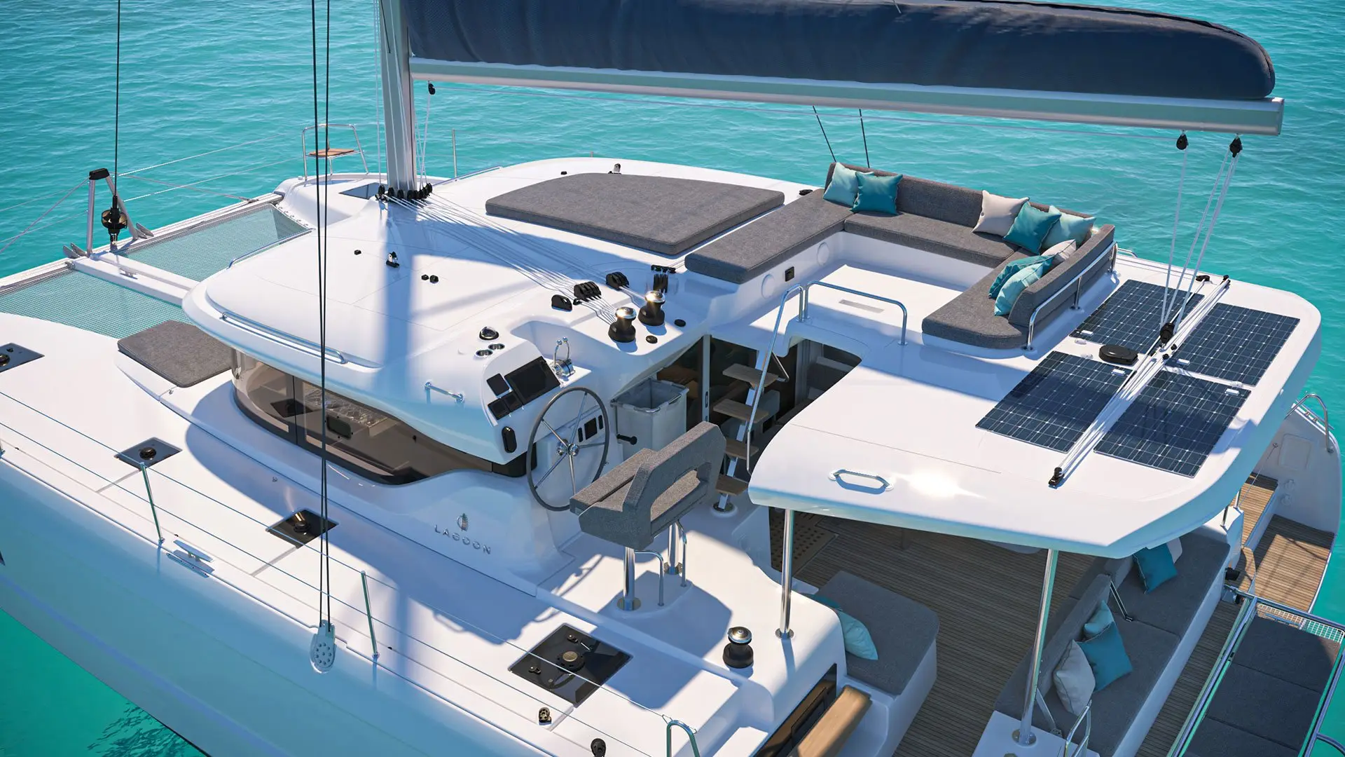 Aerial view of a modern white Lagoon 43 catamaran yacht with seating areas, sun loungers, cushions, and solar panels on deck, floating on clear turquoise water.