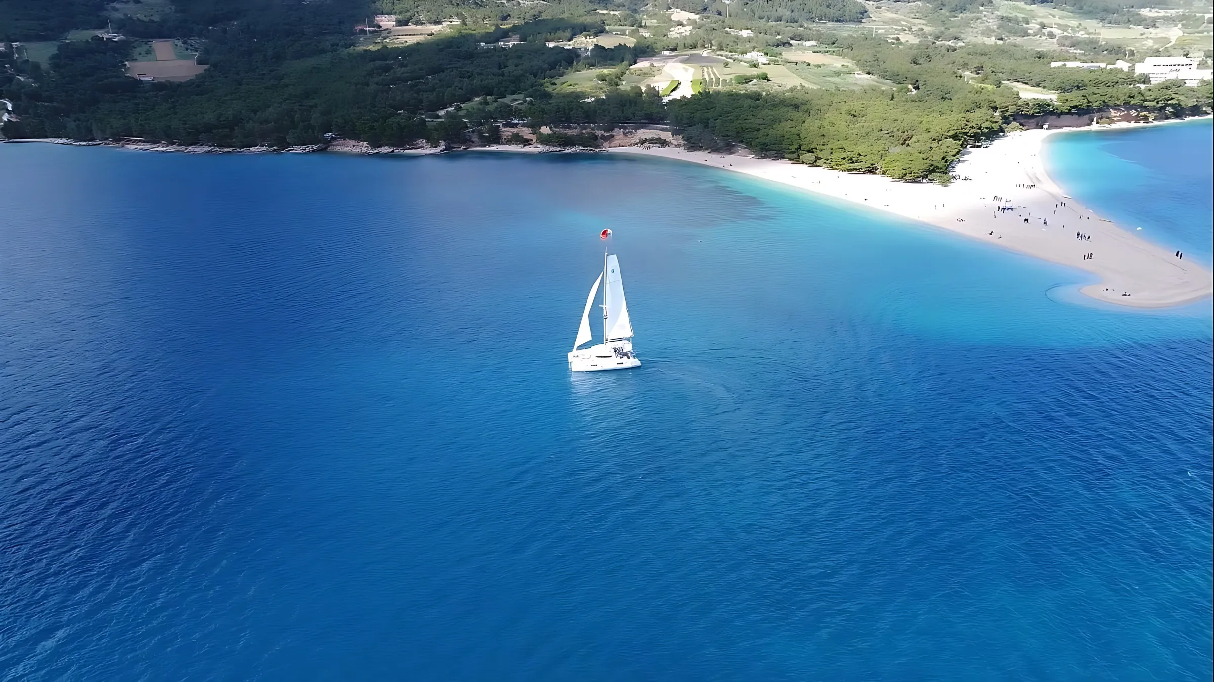 Sailboat anchored off Zlatni Rat beach on Brač, seen from the air