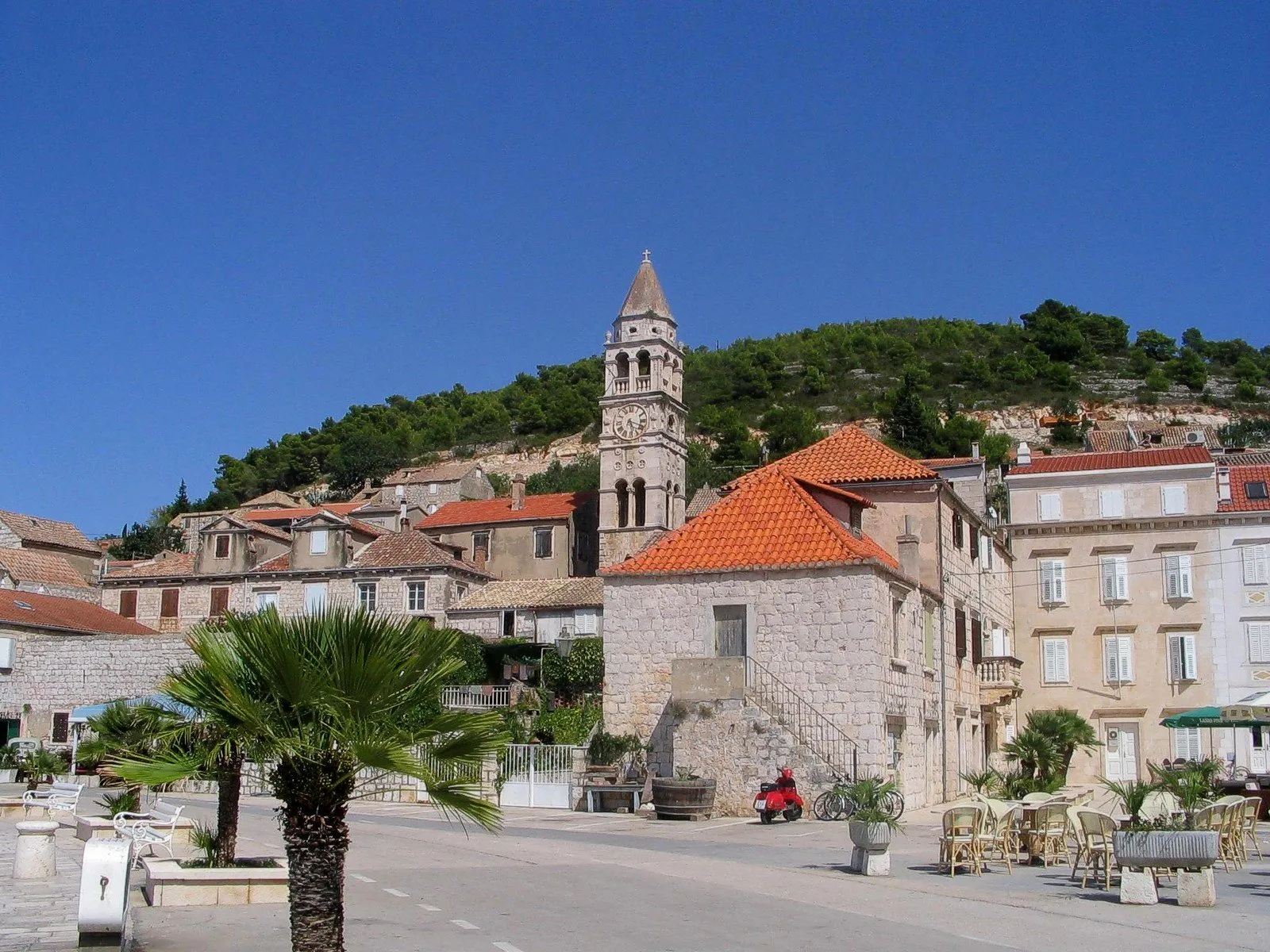 Stone houses and a church bell tower on the waterfront of Vis town.