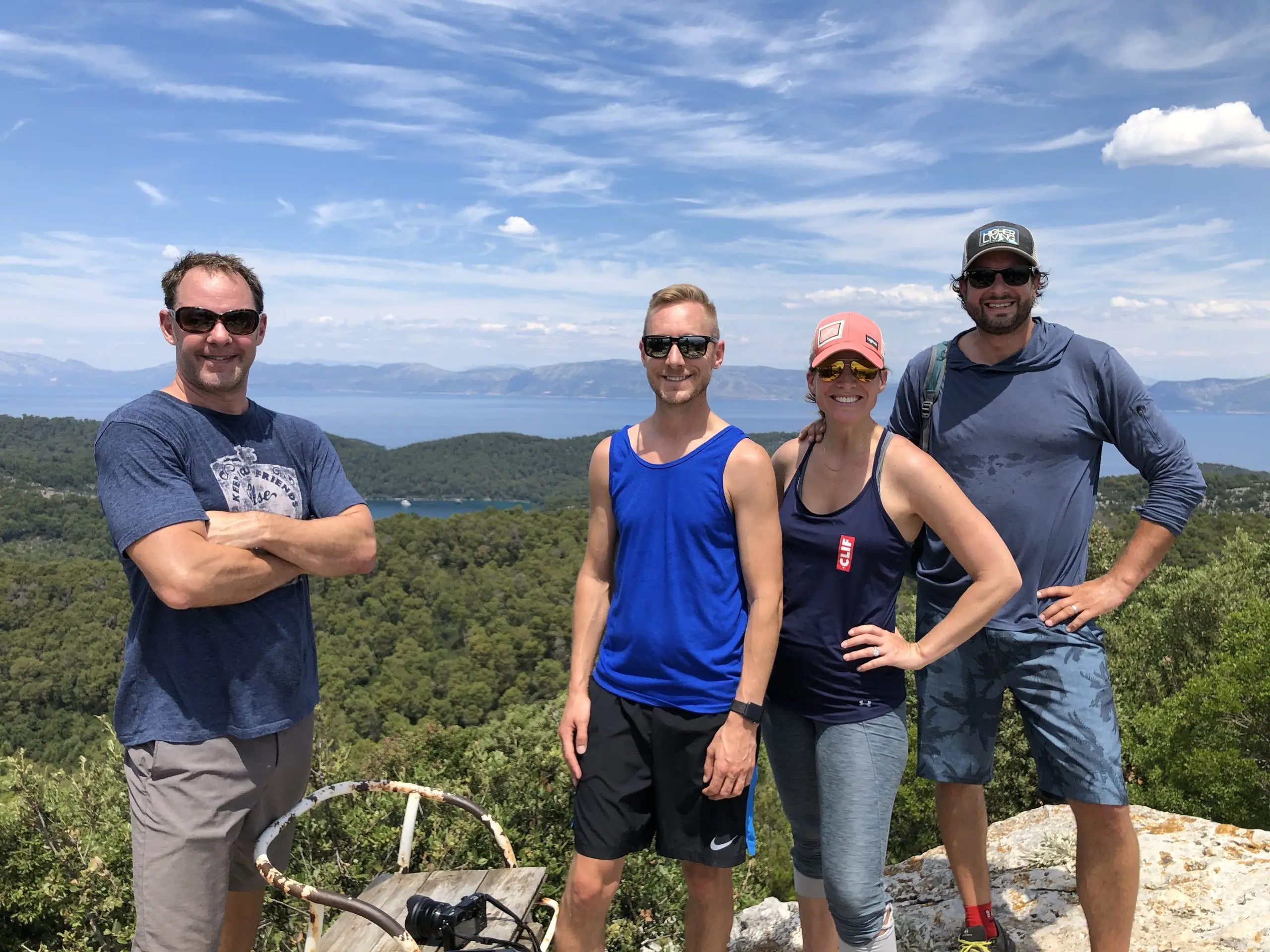 Four hikers at a viewpoint above the sea